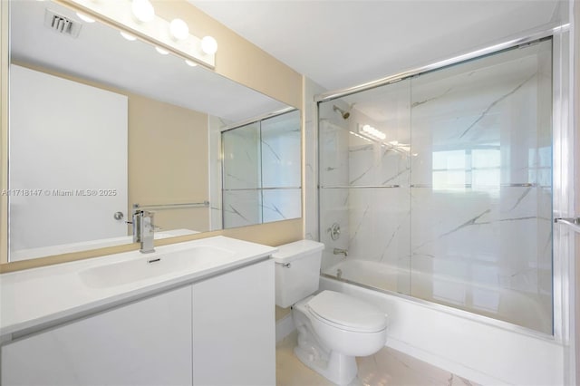 full bathroom featuring shower / bath combination with glass door, vanity, and toilet