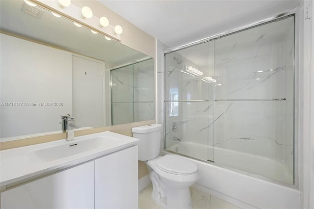 full bathroom featuring shower / bath combination with glass door, vanity, and toilet