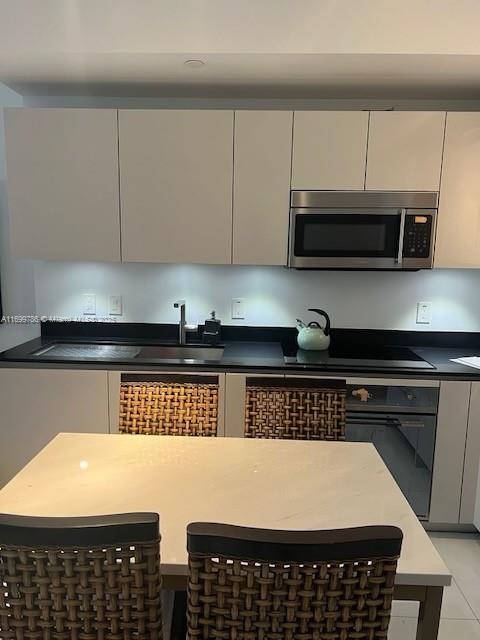 kitchen featuring black electric cooktop and oven