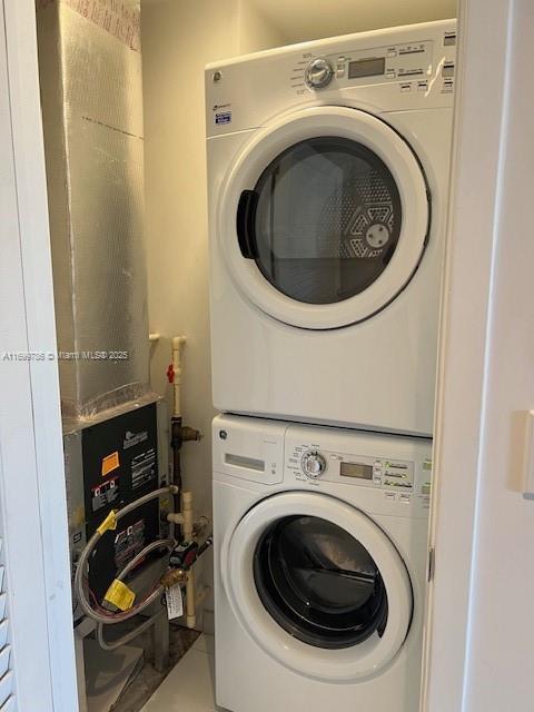 laundry room with stacked washer and dryer