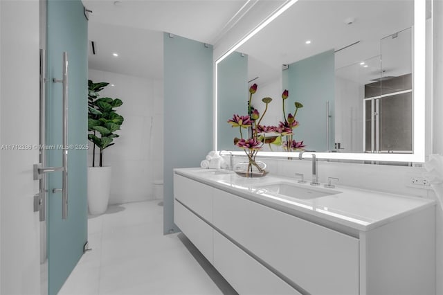 bathroom featuring a shower with door, vanity, and toilet