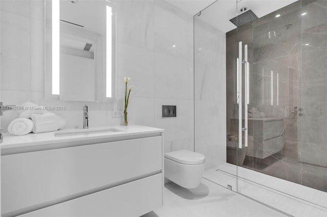 bathroom featuring a shower with door, vanity, tile walls, and toilet