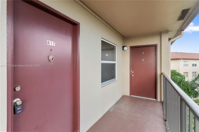 entrance to property featuring a balcony