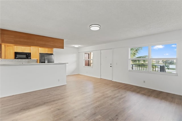 unfurnished living room featuring light wood-type flooring