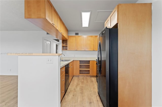 kitchen with refrigerator, sink, light brown cabinets, black dishwasher, and light hardwood / wood-style floors