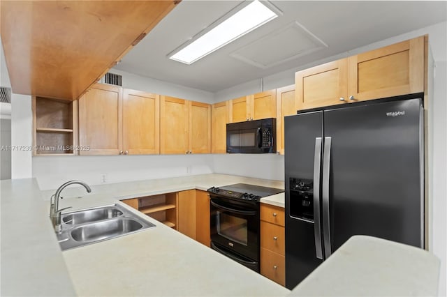 kitchen with kitchen peninsula, light brown cabinets, sink, and black appliances