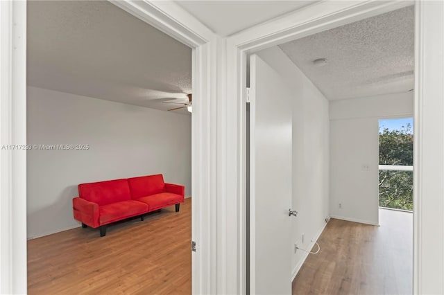 corridor featuring hardwood / wood-style floors and a textured ceiling