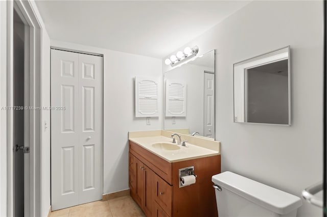 bathroom featuring tile patterned floors, vanity, and toilet