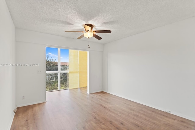 spare room featuring ceiling fan, a textured ceiling, and light hardwood / wood-style flooring