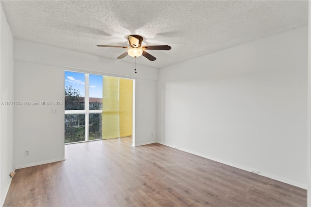 spare room with hardwood / wood-style floors, a textured ceiling, and ceiling fan