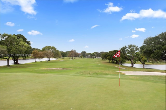 view of home's community featuring a yard and a water view