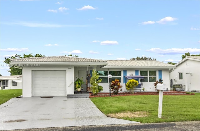 single story home featuring a garage and a front lawn