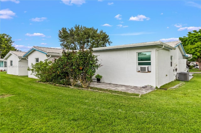 back of house with a yard, cooling unit, a patio area, and central air condition unit