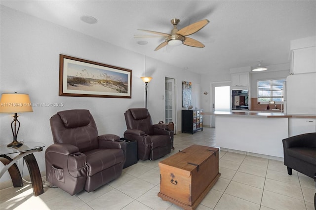 living room featuring light tile patterned floors and ceiling fan