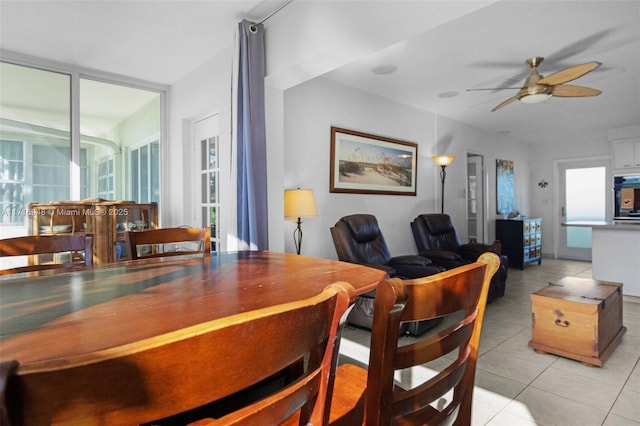 tiled dining room featuring ceiling fan