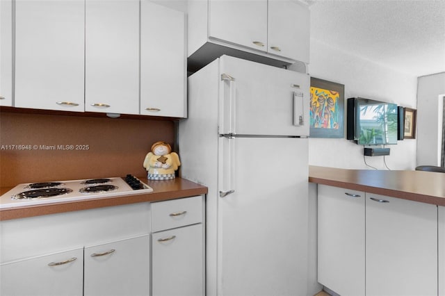 kitchen with white cabinets and white appliances