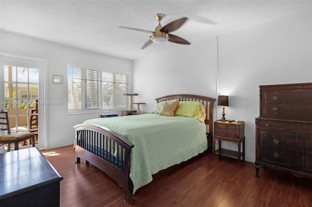 bedroom featuring multiple windows, ceiling fan, dark hardwood / wood-style flooring, and a textured ceiling