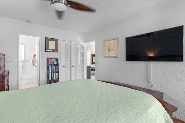 bedroom featuring connected bathroom, ceiling fan, and a textured ceiling