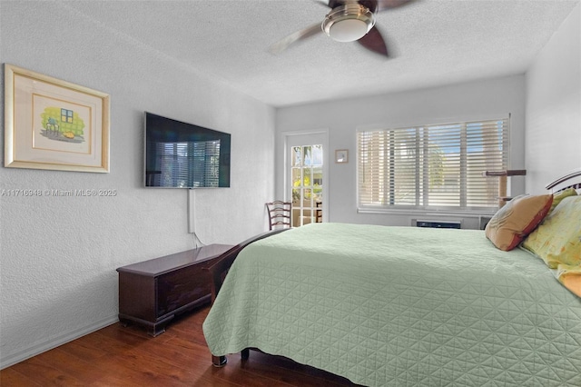 bedroom with ceiling fan, wood-type flooring, and a textured ceiling