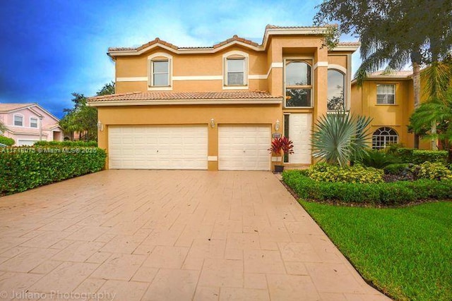 mediterranean / spanish house with a garage