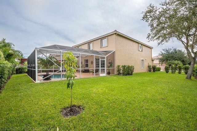 back of house with a lanai and a lawn