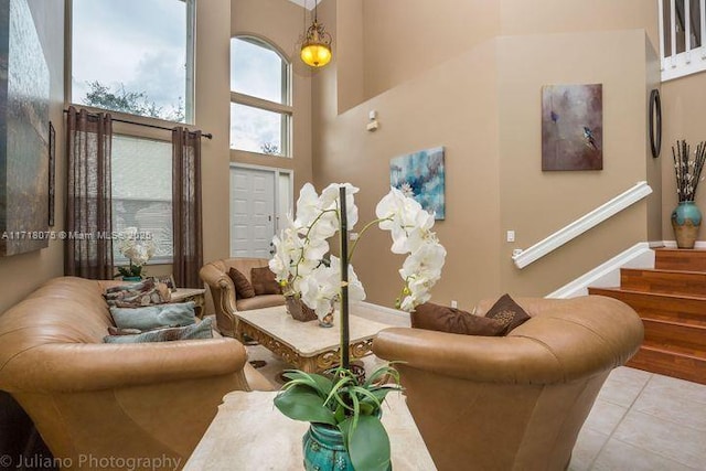 tiled living room featuring a high ceiling