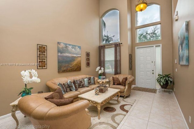 living room featuring light tile patterned floors and a towering ceiling