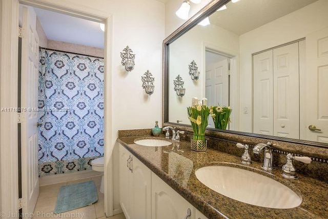 full bathroom featuring shower / bath combo with shower curtain, toilet, vanity, and tile patterned flooring