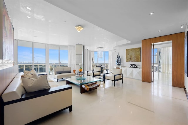 living room featuring floor to ceiling windows, light tile patterned floors, a wealth of natural light, and wood walls