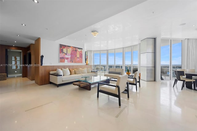 living room with expansive windows, a healthy amount of sunlight, and light tile patterned floors