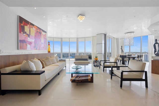 living room with floor to ceiling windows and a notable chandelier