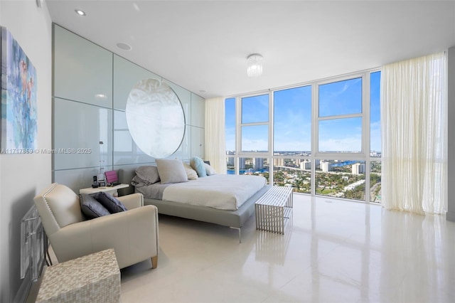 tiled bedroom featuring a wall of windows