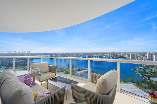 balcony featuring an outdoor living space and a water view