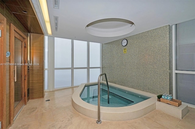 view of swimming pool with an indoor in ground hot tub