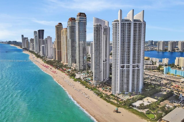 birds eye view of property with a view of the beach and a water view