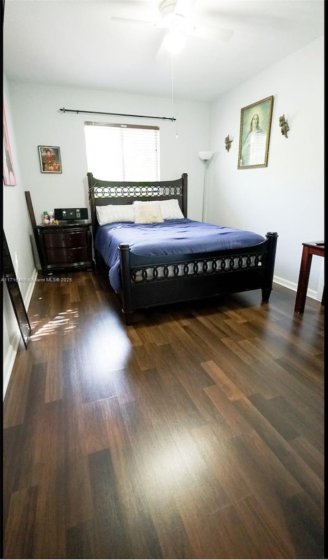 bedroom with ceiling fan and dark hardwood / wood-style flooring