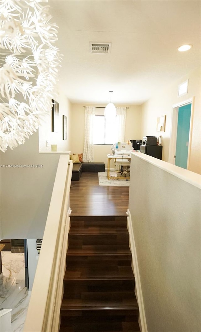 stairway with hardwood / wood-style flooring