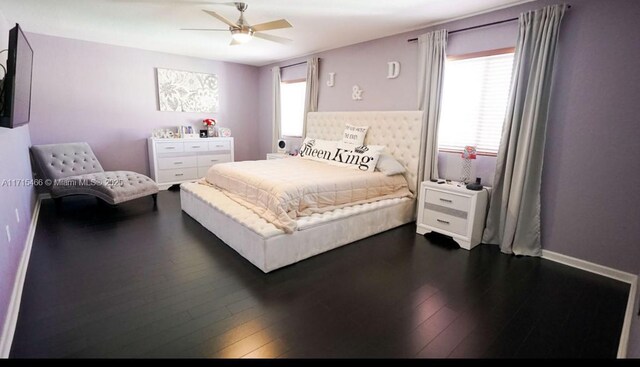 bedroom featuring multiple windows, ceiling fan, and dark wood-type flooring