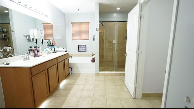 bathroom featuring tile patterned flooring, vanity, and shower with separate bathtub