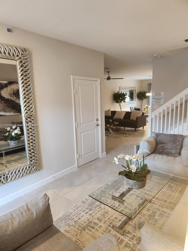 tiled living room featuring ceiling fan