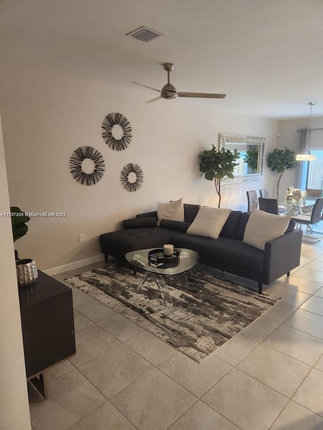 living room with light tile patterned floors and ceiling fan