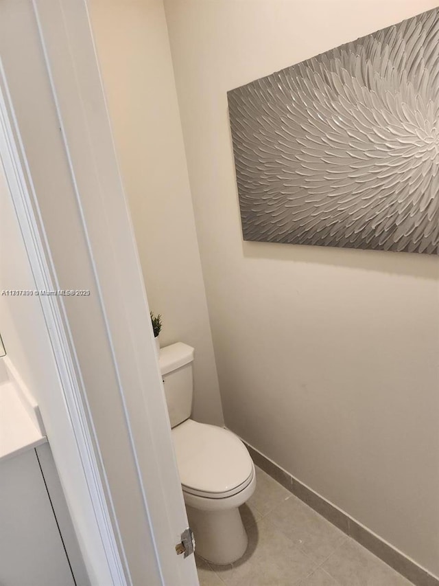 bathroom with tile patterned floors and toilet