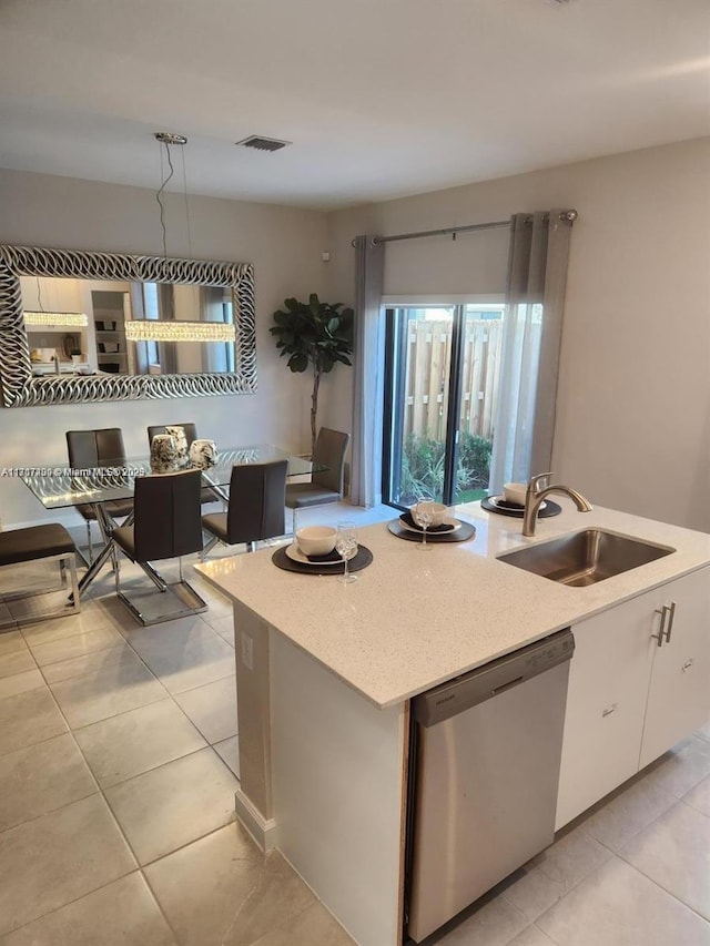 kitchen featuring dishwasher, an island with sink, white cabinets, and sink