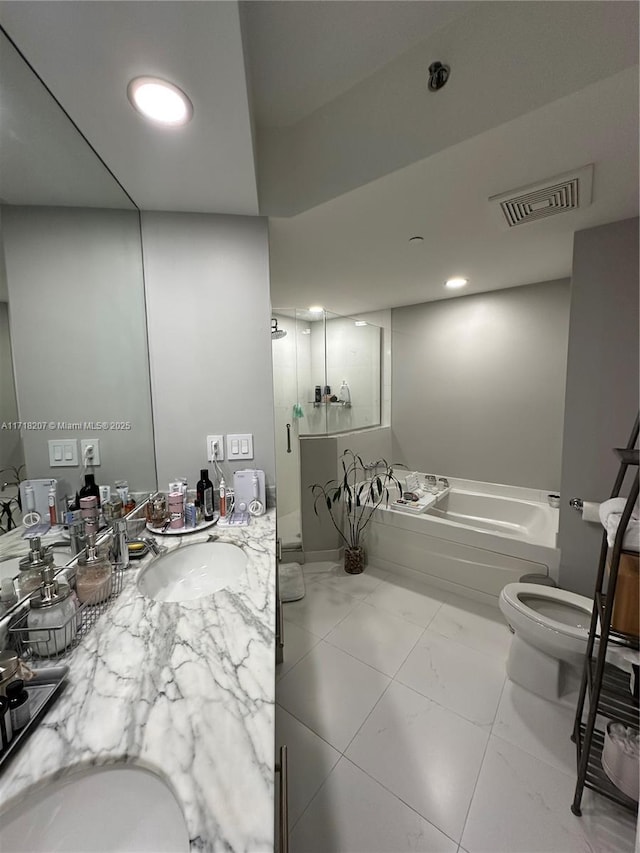 full bathroom with tile patterned floors, separate shower and tub, vanity, and toilet