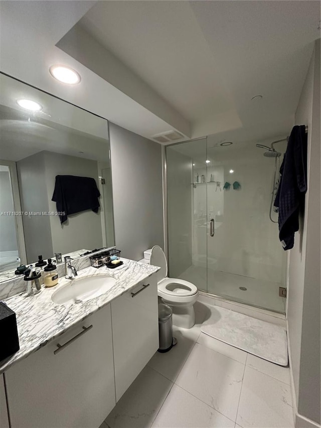 bathroom with tile patterned floors, a shower with door, vanity, and toilet