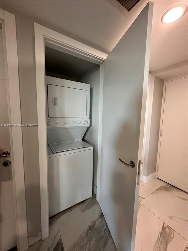 laundry room with stacked washer and clothes dryer