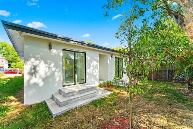 rear view of property with a yard