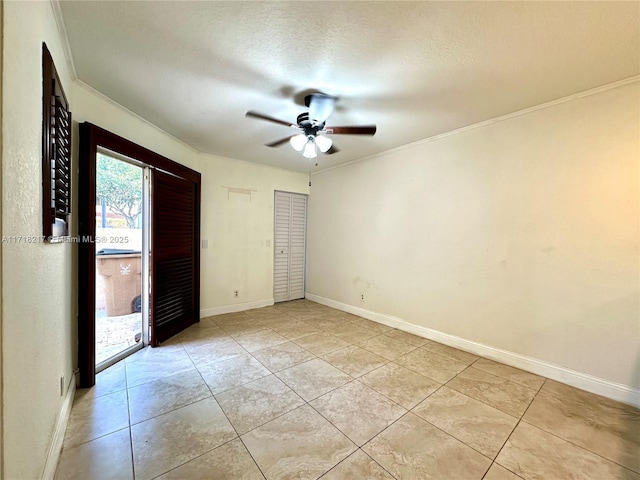 unfurnished bedroom featuring ornamental molding, a textured ceiling, ceiling fan, light tile patterned floors, and a closet