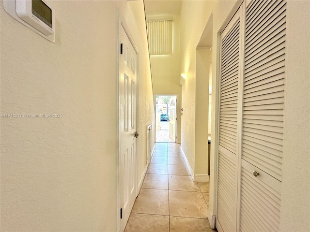 hallway featuring light tile patterned floors