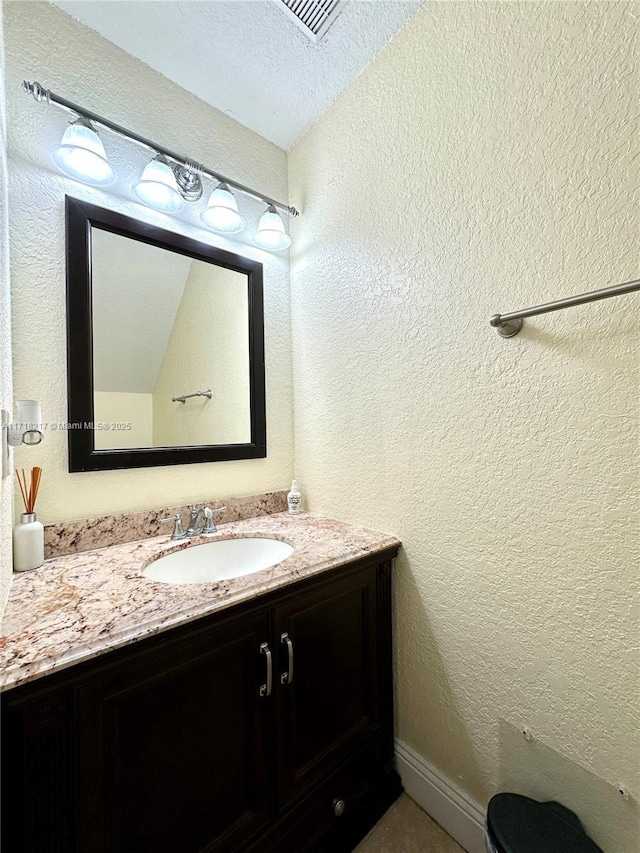 bathroom featuring vanity and a textured ceiling